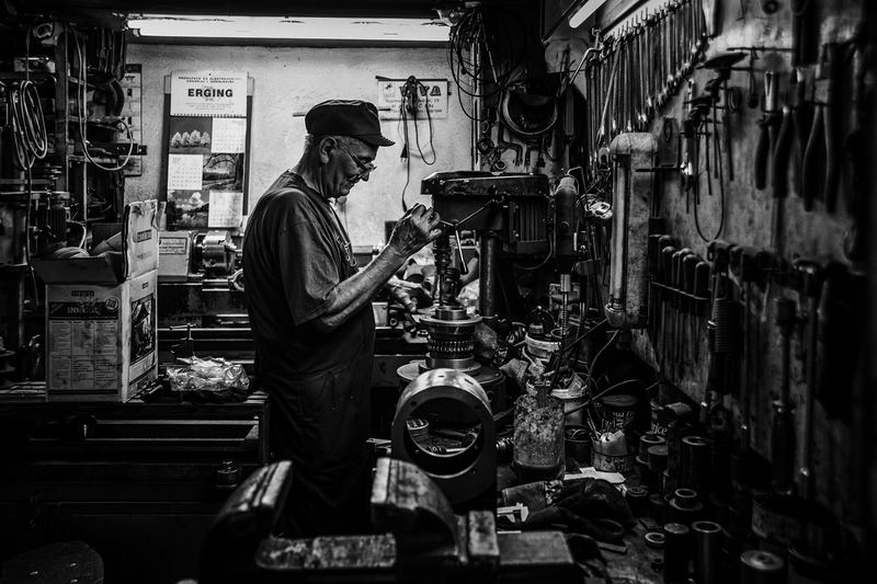 Locksmith at a workbench in a traditional workshop